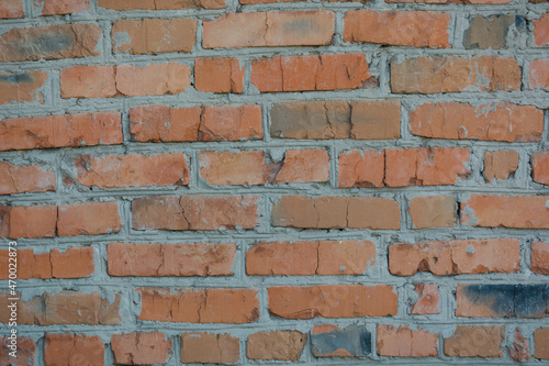 Brick wall. Brick background. Red brick. Close-up of the wall. Masonry. Cement-based bricks. Home construction.