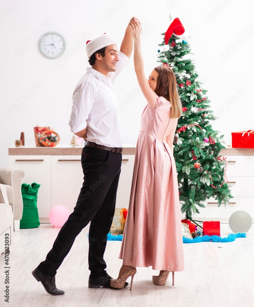 Young pair celebrating christmas at home Young pair celebrating christmas at home