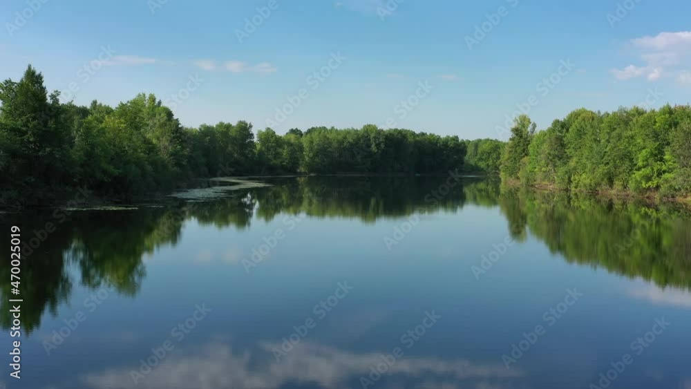Flying over the calm summer lake in forest, sky reflection, 4k Flying over the calm summer lake in forest, sky reflection, 4k