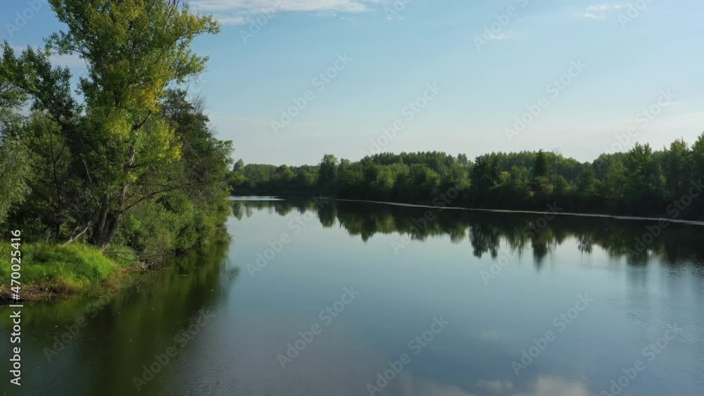 Flying over the calm summer lake in forest, sky reflection, 4k Flying over the calm summer lake in forest, sky reflection, 4k