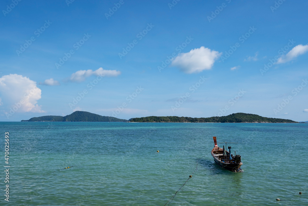 Tropical sea with LongTail boat in the turquoise sea on Paradise island in Phuket Thailand and white clouds in summer season Beautiful Landscape nature view background