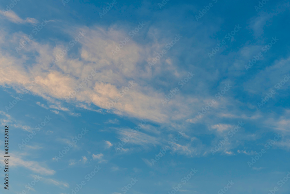 Puffy altocumulus clouds in a blue sunrise sky