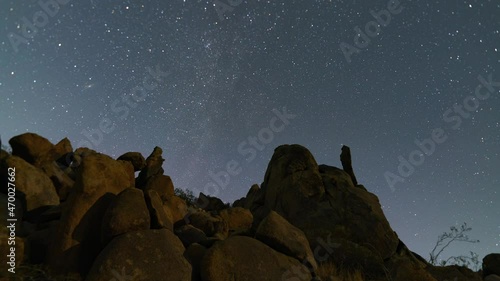 Time lapse of star trails over rugged rock formations in Mojave Desert, California  photo