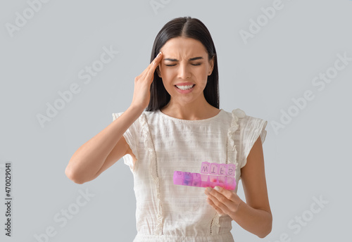 Sick woman with pills in bo...