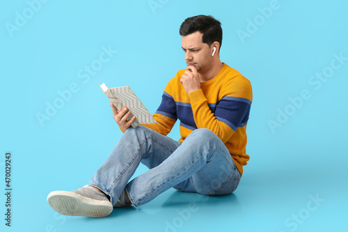 Frowning man with book and ...