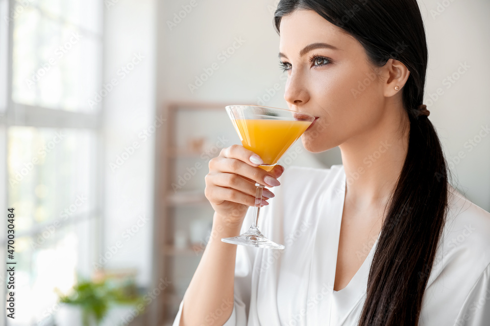 Pretty young woman drinking cocktail in bathroom Pretty young woman drinking cocktail in bathroom