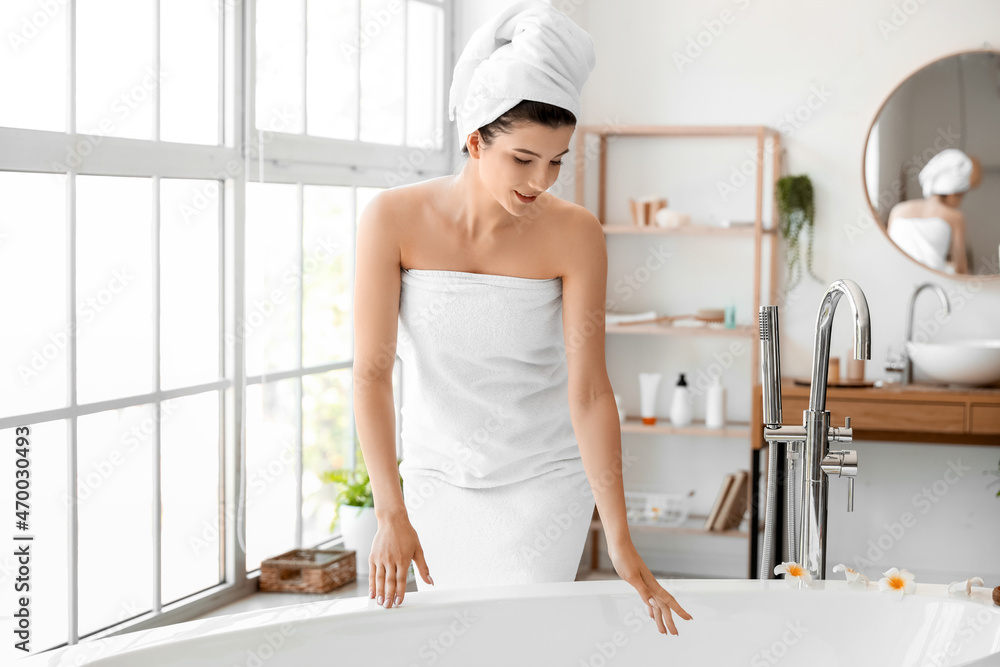 Pretty young woman getting ready to take bath at home Pretty young woman getting ready to take bath at home