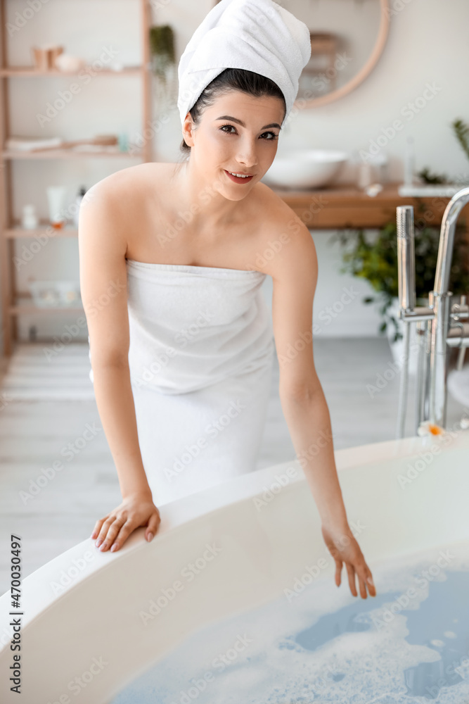 Pretty young woman getting ready to take bath at home Pretty young woman getting ready to take bath at home