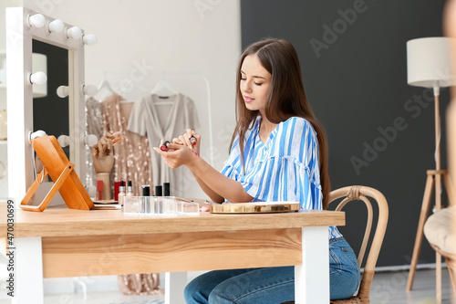 Pretty young woman applying...