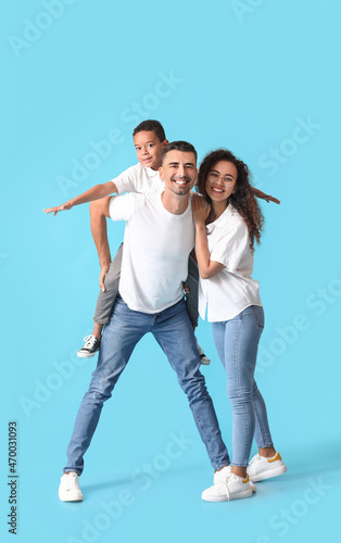 Happy interracial family on color background