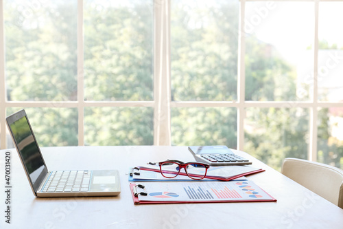 Documents with laptop, eyeg...