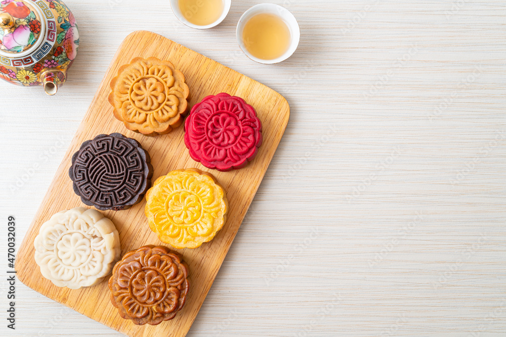 colourful Chinese moon cake on wood plate