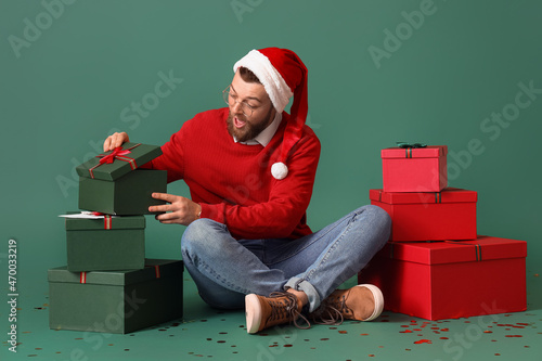 Surprised man with heap of ...