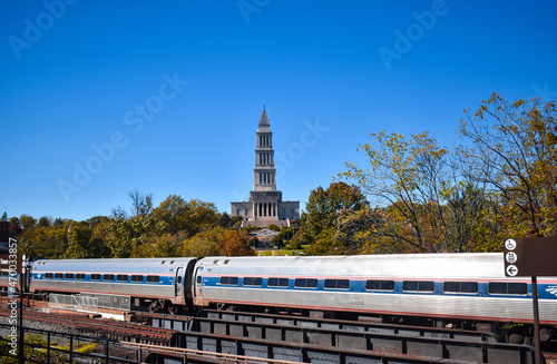 Alexandria, Virginia, USA - November 1, 2021: King Street  - Old Town WMATA Metro Station, looking at the George Washington Masonic Temple, with an Amtrak Train in the Foreground on a Fall Afternoon photo