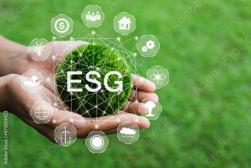 Hands holding the green ball that writes the word ESG with ESG icon concept for environmental. Nature Сonservation, Ecology, Social Responsibility and Sustainability.