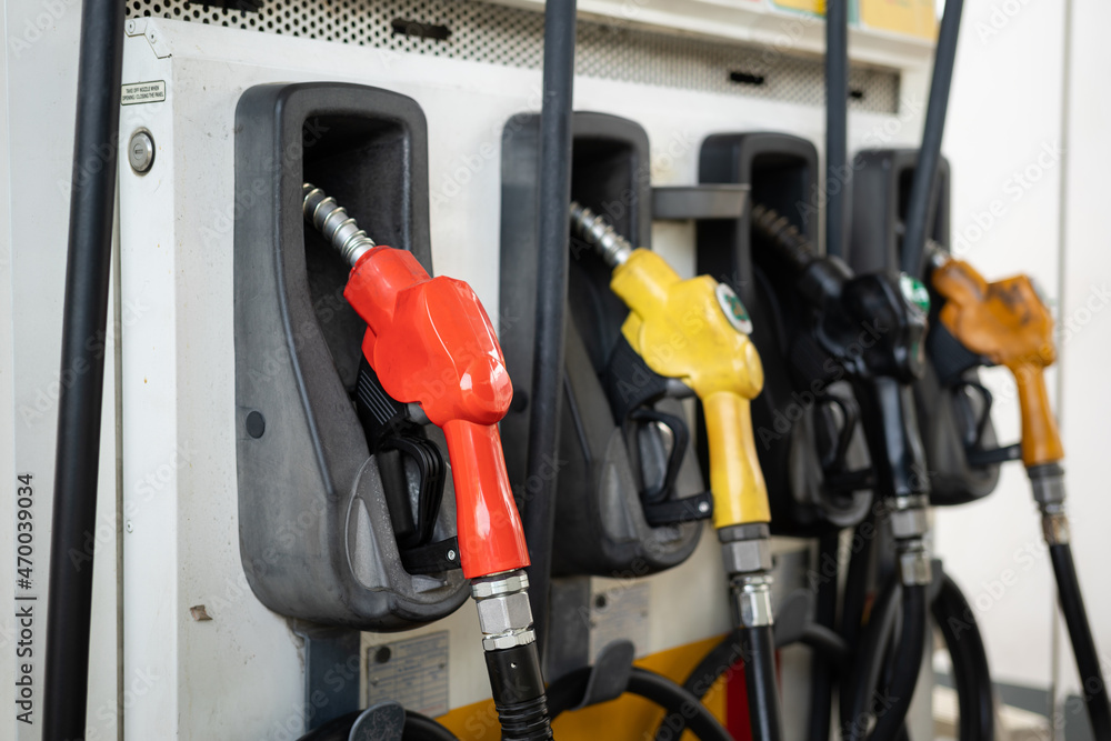 Row of refuel nozzle head at gasoline station. Transportation energy and equipment object photo. Close-up and selective focus. Row of refuel nozzle head at gasoline station. Transportation energy and equipment object photo. Close-up and selective focus.