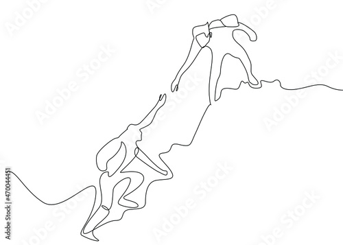 teammates climbing in nature helping each other. The person at the top takes a hand at the person climbing. Leading person helping the following. adrenaline filled moments in nature