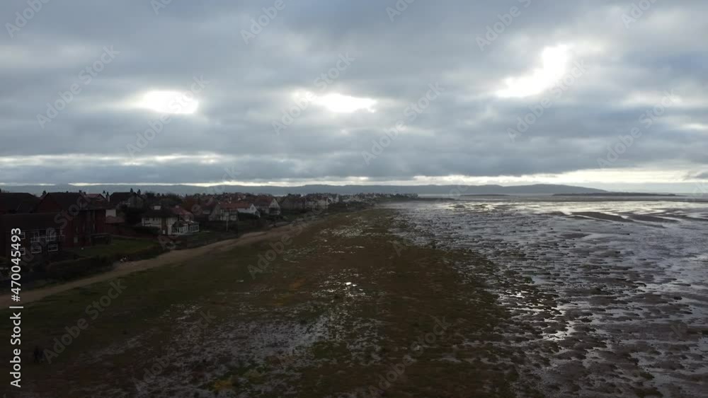 A push towards the horizon, over the moody beach and towards the houses near the shore. A push towards the horizon, over the moody beach and towards the houses near the shore.