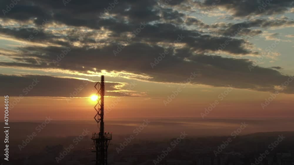 Dawn over the city of Irkutsk. The sun rises over the TV tower. Swallows fly by against the background of the rising sun. Shooting from a drone. Top view Dawn over the city of Irkutsk. The sun rises over the TV tower. Swallows fly by against the background of the rising sun. Shooting from a drone. Top view