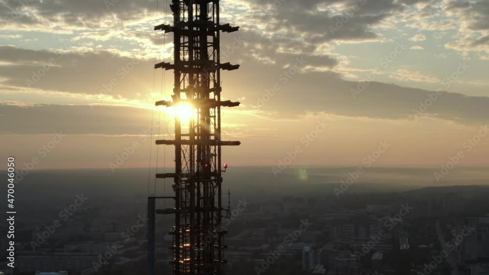 Dawn over the city of Irkutsk. The sun rises over the TV tower. Swallows fly by against the background of the rising sun. Shooting from a drone. Top view Dawn over the city of Irkutsk. The sun rises over the TV tower. Swallows fly by against the background of the rising sun. Shooting from a drone. Top view