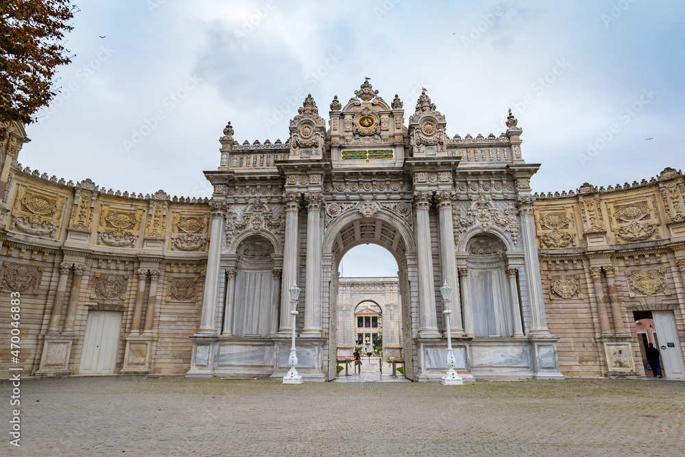 Fototapeta premium Dolmabache palace main entrance gate in Istanbul, Turkey. Dolmabache served as the main administrative center of the Ottoman Empire and is popular for tourists and visitors.