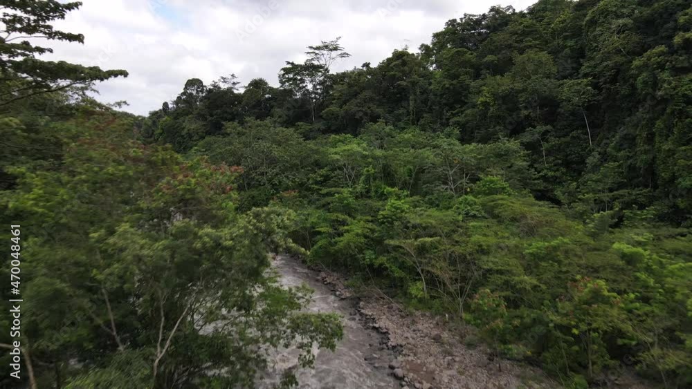 Rio Peñas Blancas captured from above. Brown river meandering through the thick and vast rainforests of Alajuela, Costa Rica. 4k cinematic drone footage flying backwards revealing stunning nature. Rio Peñas Blancas captured from above. Brown river meandering through the thick and vast rainforests of Alajuela, Costa Rica. 4k cinematic drone footage flying backwards revealing stunning nature.