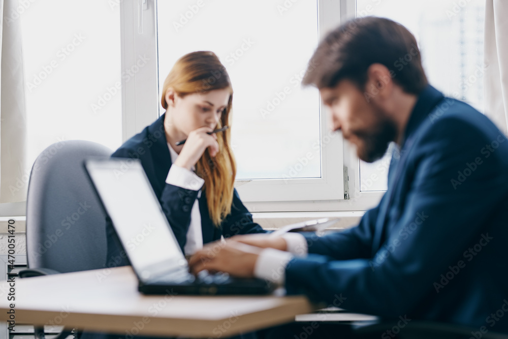 business man and woman sitting in front of a laptop teamwork internet technologies business man and woman sitting in front of a laptop teamwork internet technologies