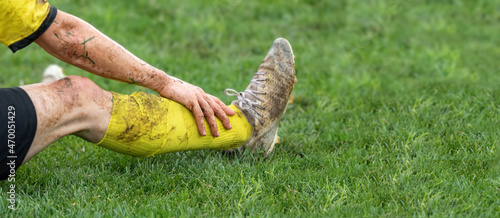 Obraz na plátně Soccer, football concept. Injured footballer lay down on field.