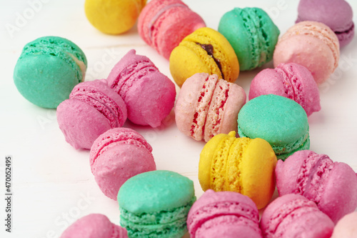 Pile of colorful macarons on white background