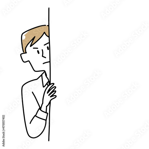 壁の向こうから覗いている男性
