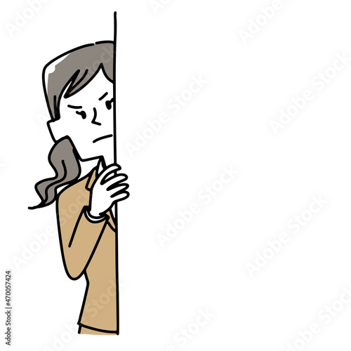 壁の向こうから覗いている女性