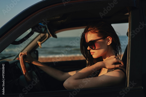 cheerful woman in sunglasses driving a car trip travel © VICHIZH