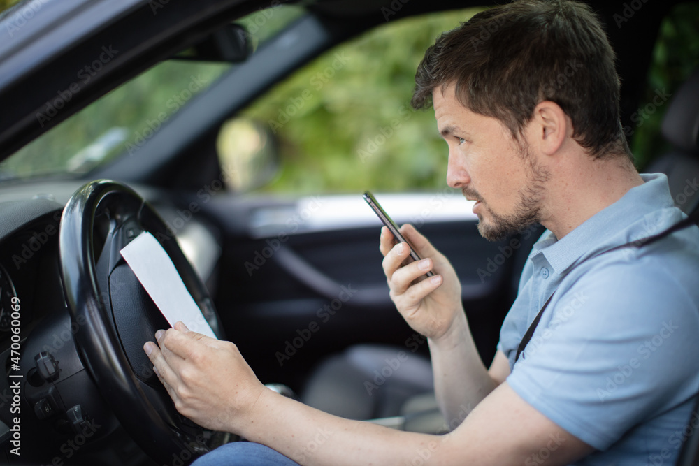 man driving car and speaking on mobile phone