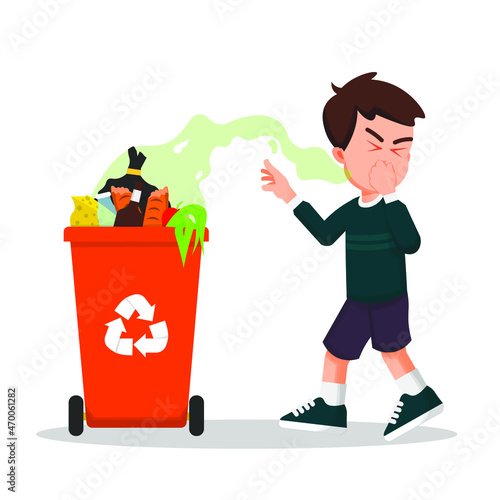 Boy covered his nose because of the very bad smell from the trash can