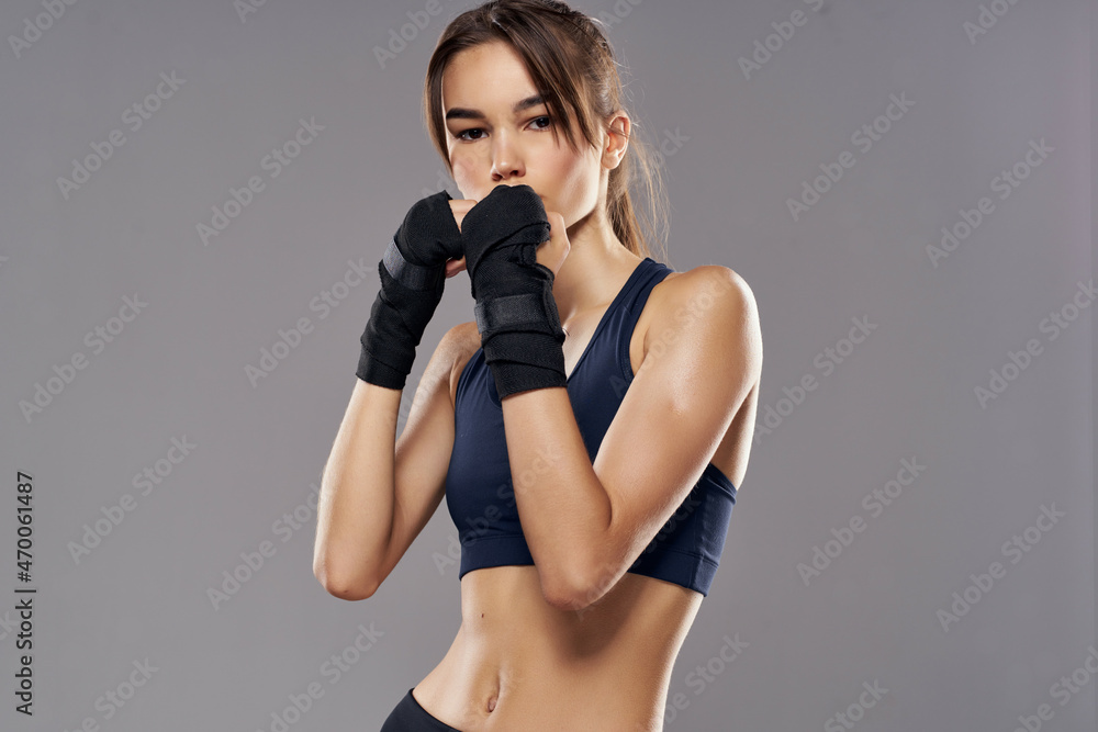 Fototapeta premium pretty woman boxing punching workout bandages isolated background