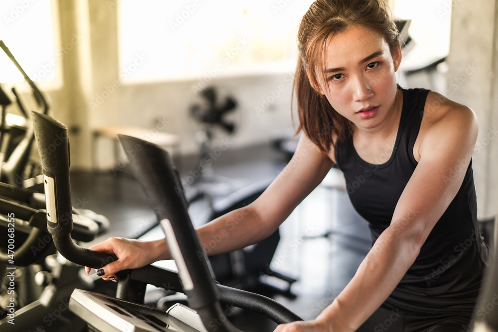 Portrait asia woman exercise is wearing sportswear in fitness or gym center, Strength sporty female and weight loss concept Portrait asia woman exercise is wearing sportswear in fitness or gym center, Strength sporty female and weight loss concept