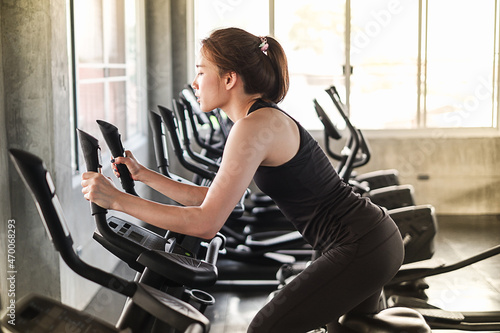 Portrait asia woman exercise is ​wearing sportswear in fitness or gym center, Strength sporty female and weight loss concept © u photostock