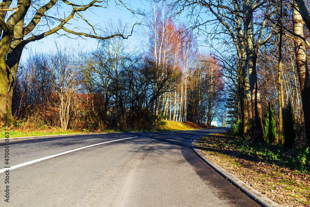 Beautiful scenic empty road in the fall.winding road curves through autumn trees landscape. Beautiful scenic empty road in the fall.winding road curves through autumn trees landscape.