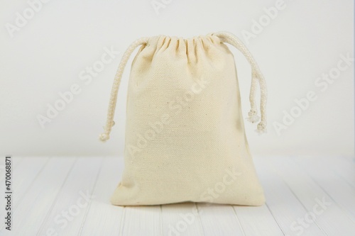 Small canvas sack, muslin drawstring favor or gift bag mockup for design presentation.