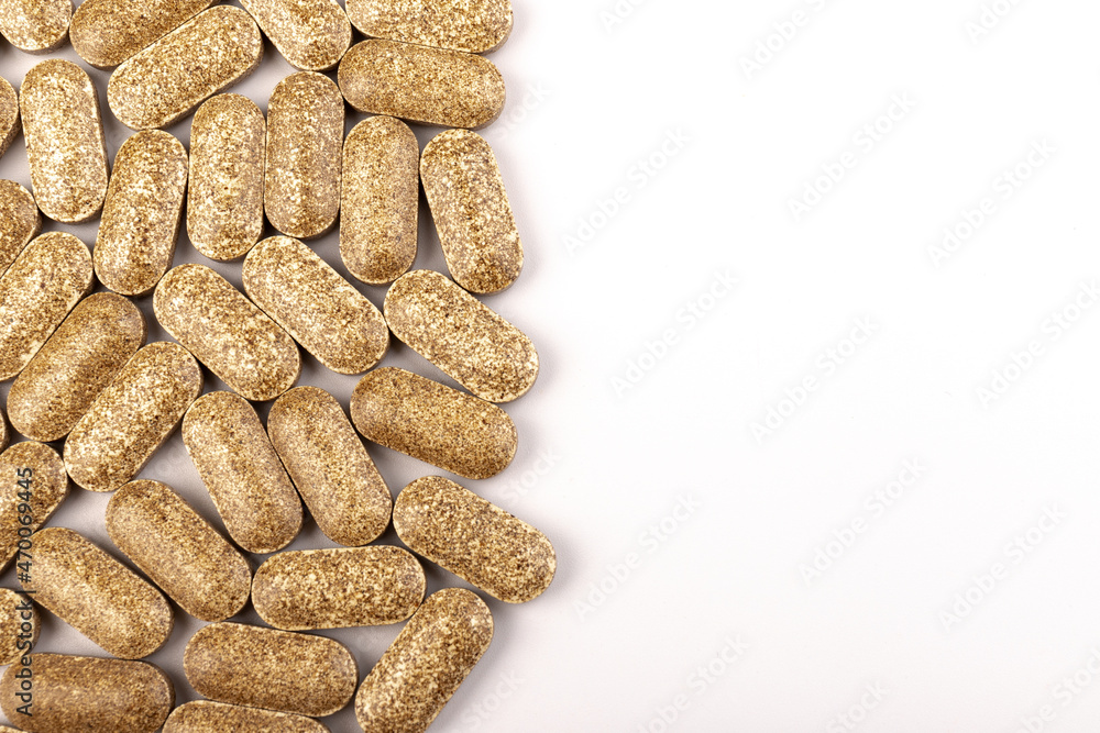 Nutrition supplements, brown vitamin pills on white background. Nutrition supplements, brown vitamin pills on white background.