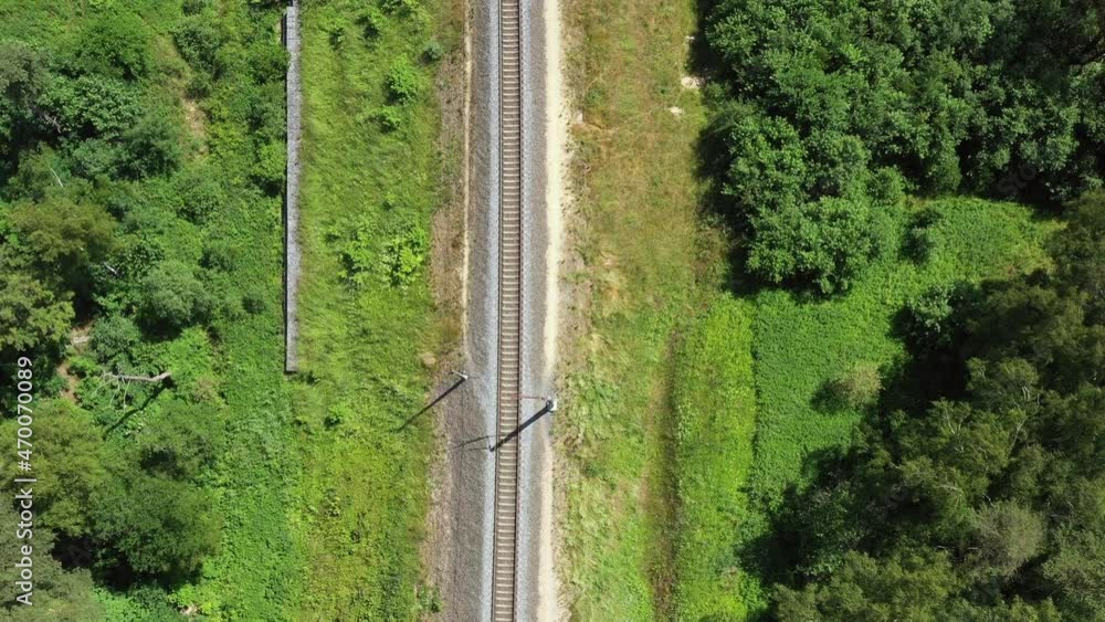 Railway through summer forest. Aerial view from drone Railway through summer forest. Aerial view from drone