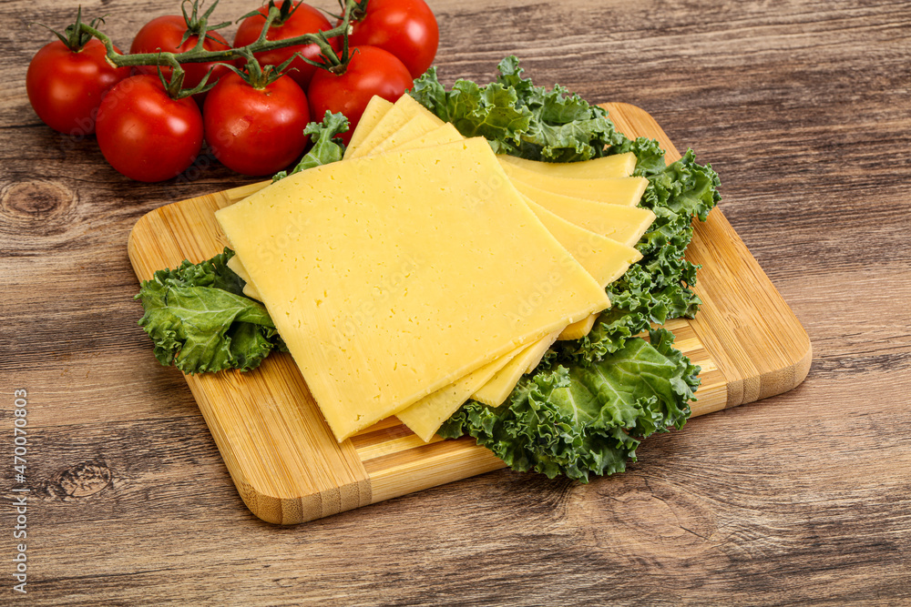Sliced Gauda cheese over board Sliced Gauda cheese over board