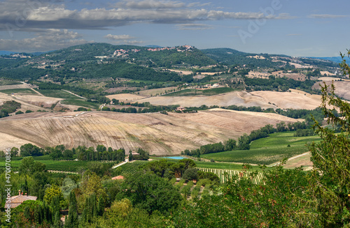 Montepulciano, Tuscany, Italy. August 2020. Amazing landscape of the Tuscan countryside. At the top of the hill the village. Beautiful summer day