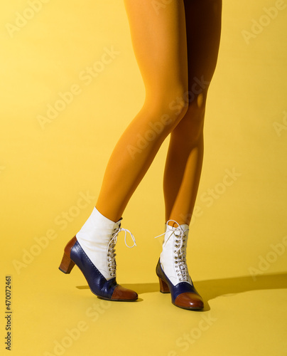 Woman with shapely legs wearing mustard coloured pantyhose