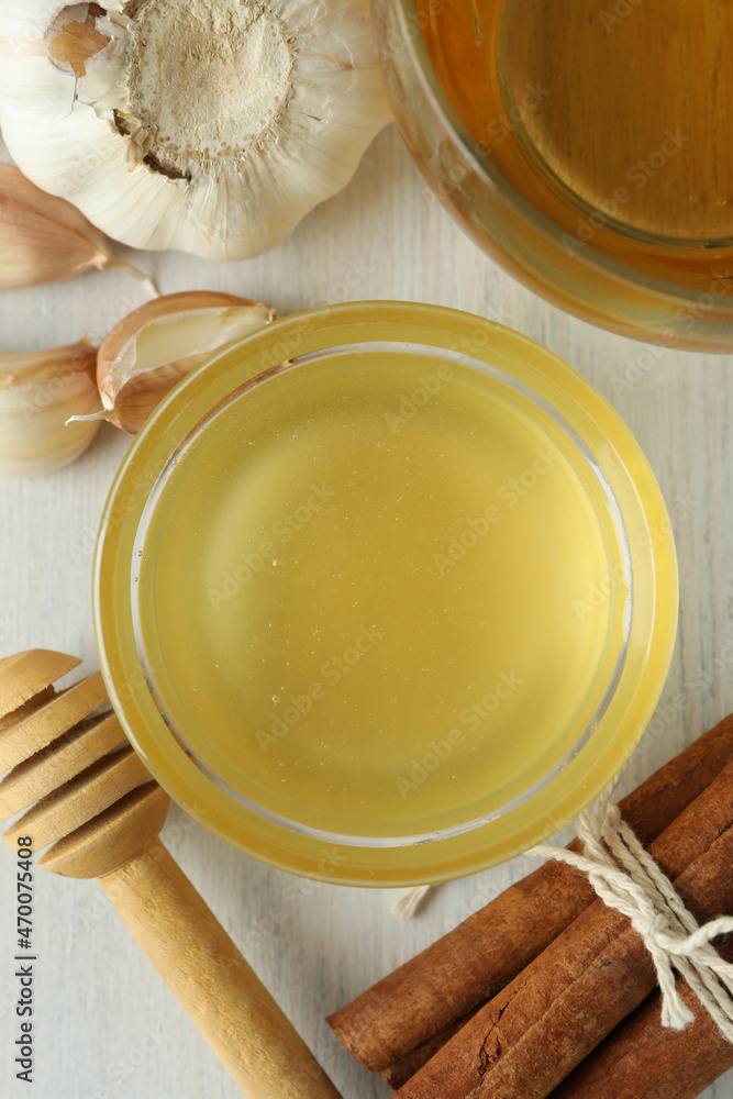 Concept of treatment colds with honey and garlic, close up Concept of treatment colds with honey and garlic, close up