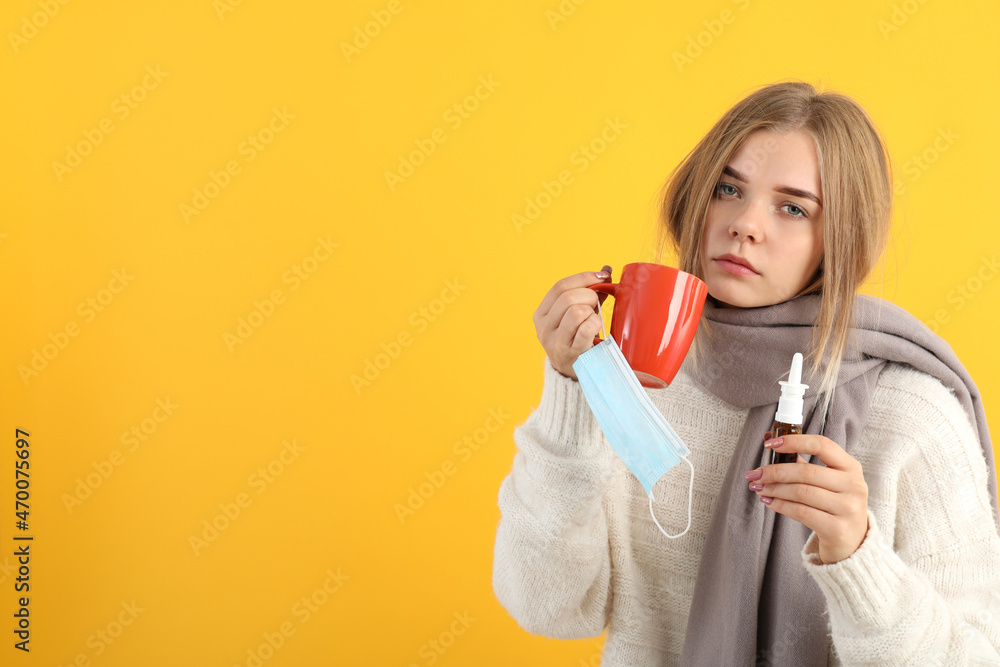 Ill young woman on yellow background, seasonal cold concept Ill young woman on yellow background, seasonal cold concept