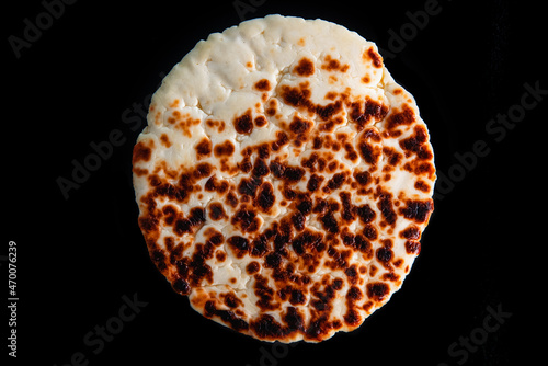 Fotografie Traditional finnish squeaky cheese on black background.