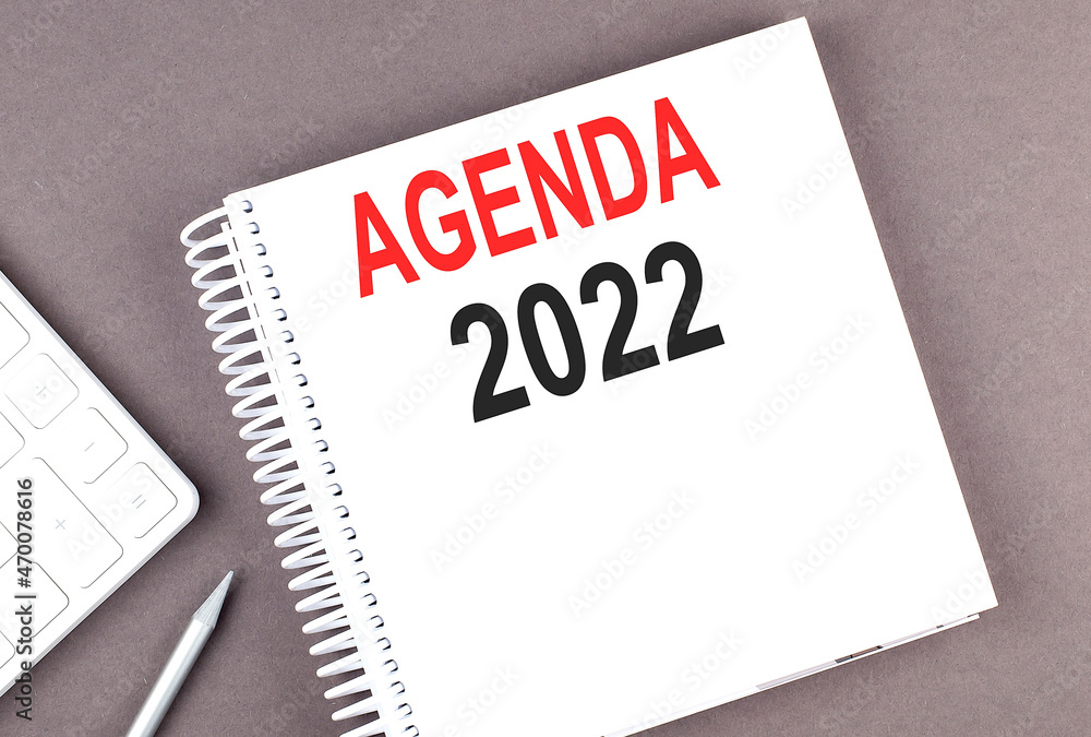 AGENDA 2022 text on notebook with calculator and pen AGENDA 2022 text on notebook with calculator and pen