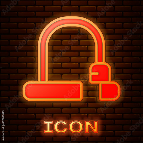 Glowing neon Bicycle lock U shaped industrial icon isolated on brick wall background. Vector