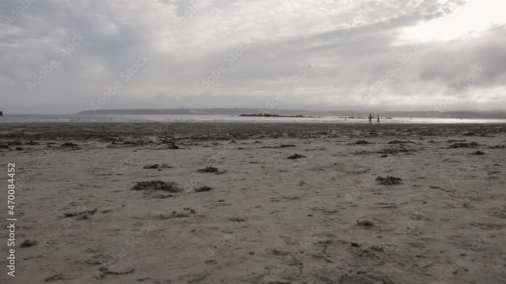 Clouds over Marazion Beach at St Michael's Mount in Cornwall near Penzance - Slow Motion with People Playing in the Background Clouds over Marazion Beach at St Michael's Mount in Cornwall near Penzance - Slow Motion with People Playing in the Background